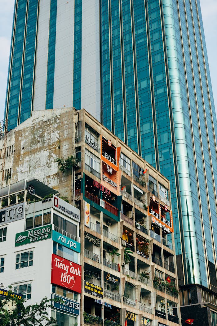 A striking contrast of vintage cafe apartments and a modern skyscraper in Ho Chi Minh City, Vietnam.